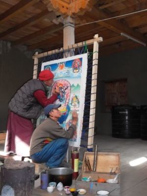 Shashi and Chakra painting a thangka in the library